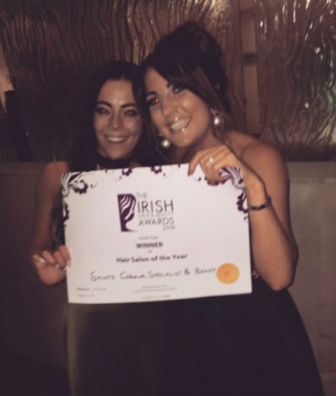 Two of the team holding the Irish Hair & Beauty Awards 2016 certificate: South East winner of Hair Salon of the Year, Saints Colour Specialist & Beauty.