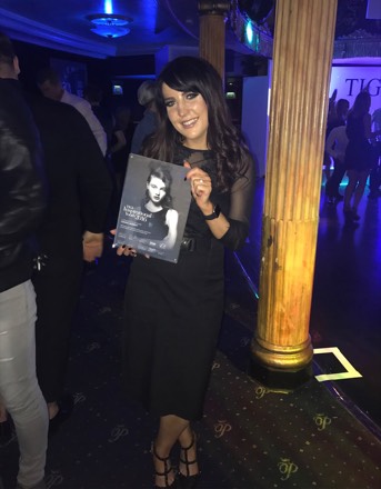 Louisa Murphy holding her TIGI certificate, 2016.