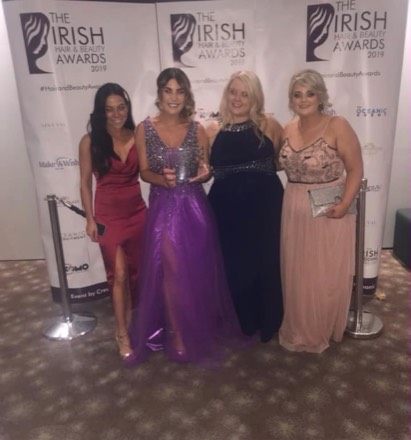 Four of the Saints team at the Irish Hair & Beauty Awards 2019, holding the trophy.