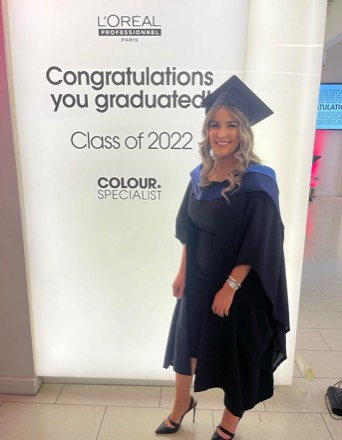 Louisa Murphy in cap and gown at the L’Oréal Professionnel Colour Specialist graduation, class of 2022.