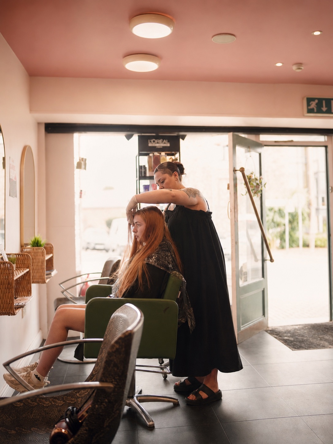 A stylist working on a client by the window at Saints in Ferns.