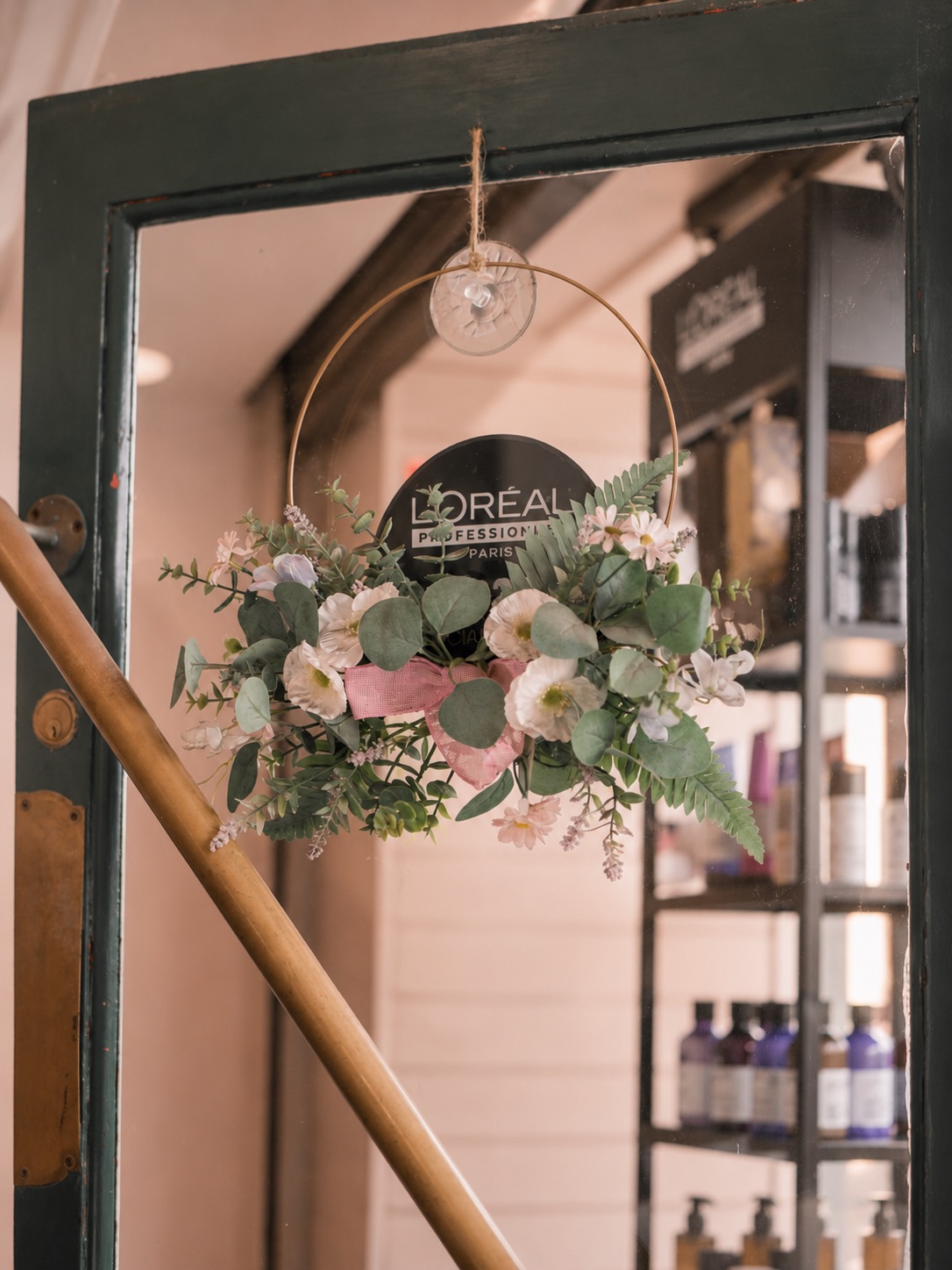 A flower wreath hanging on the salon door.